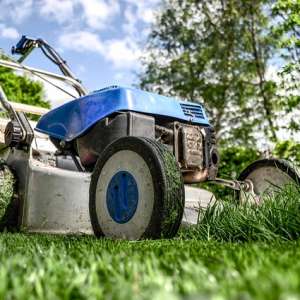 A lawn mower on the green lawn