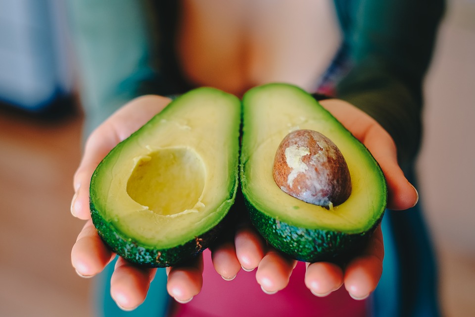 A nutritionist with ripen avocados in hands