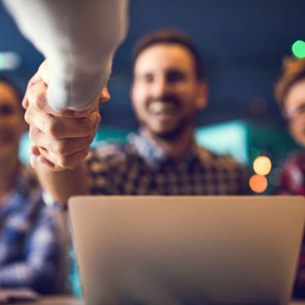 Happy real estate agent greets a client