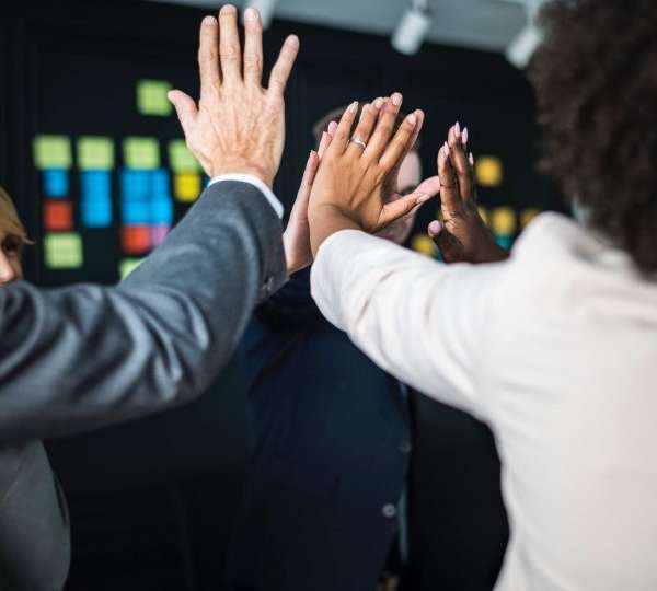 Business people cheer up together with their hands