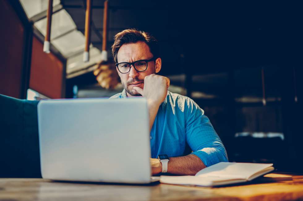 An engineer looks at laptop during design work