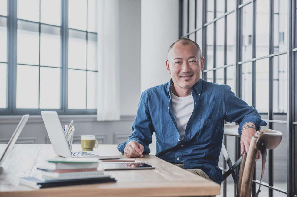 A business person in the office sitting in a chair.