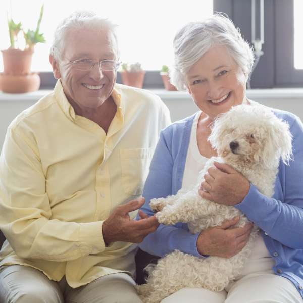 Happy and healthy senior with a small puppy
