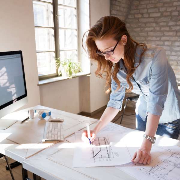 Female architect in office working on architects project