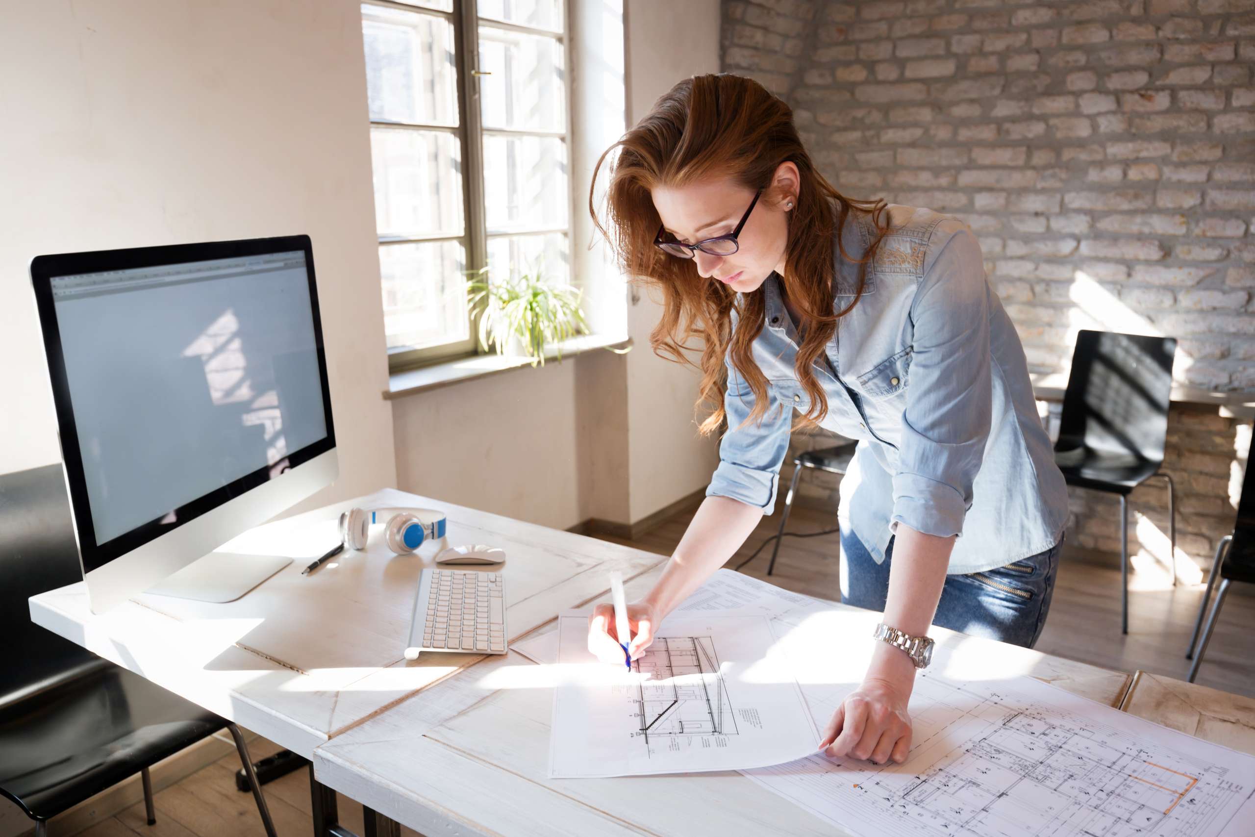 Female architect in office working on architects project