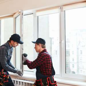 Handymen install a window
