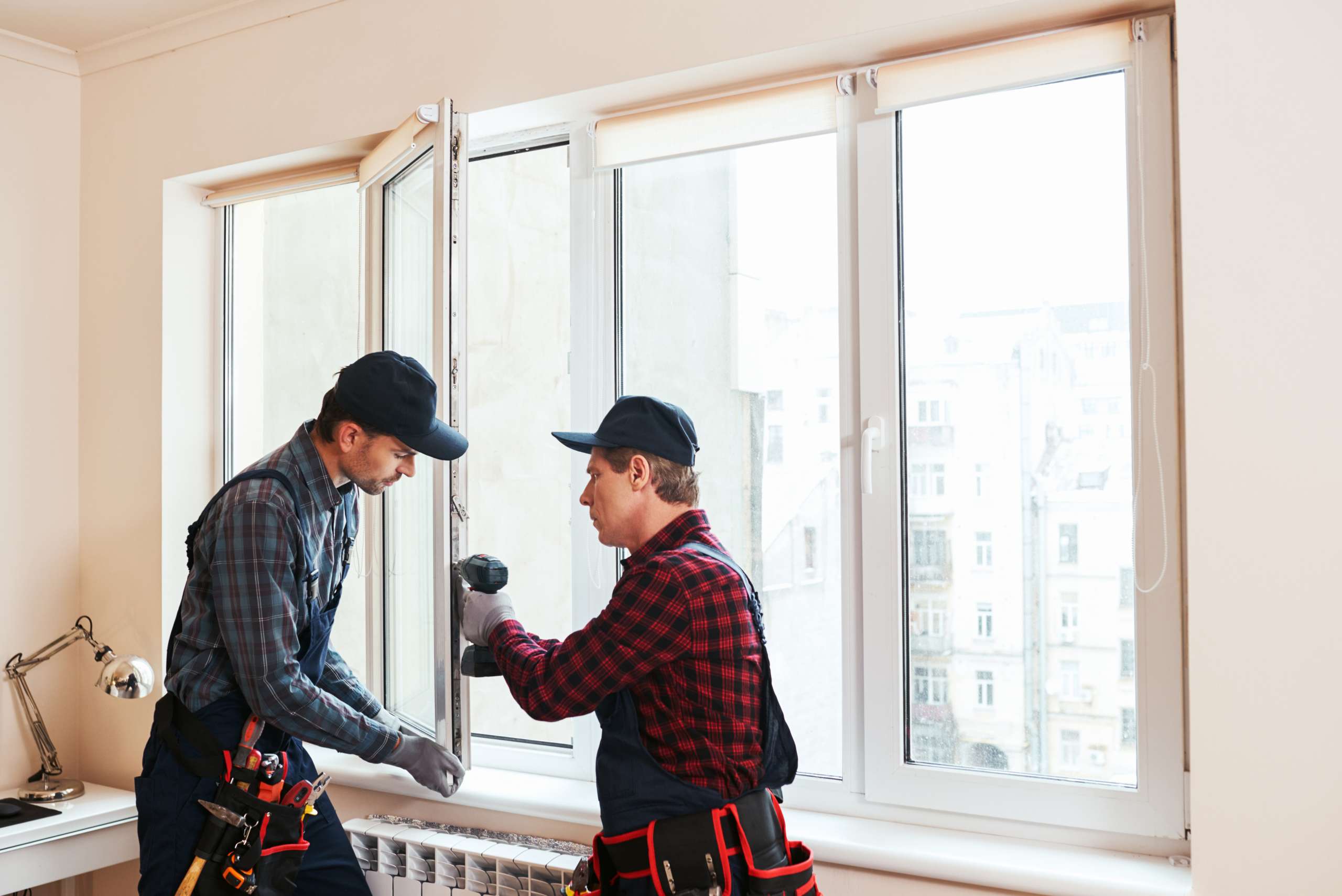 Handymen install a window