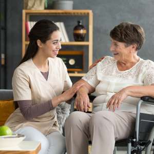 Smiling carer and elderly person