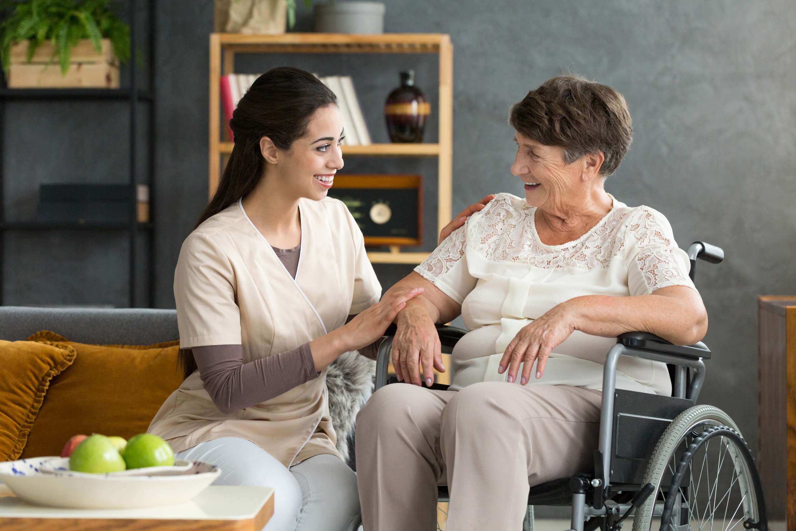 Smiling carer and elderly person