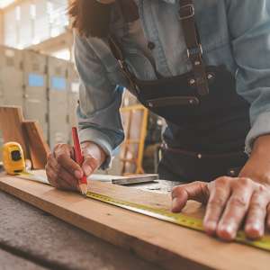 A carpenter works with carpentry tools