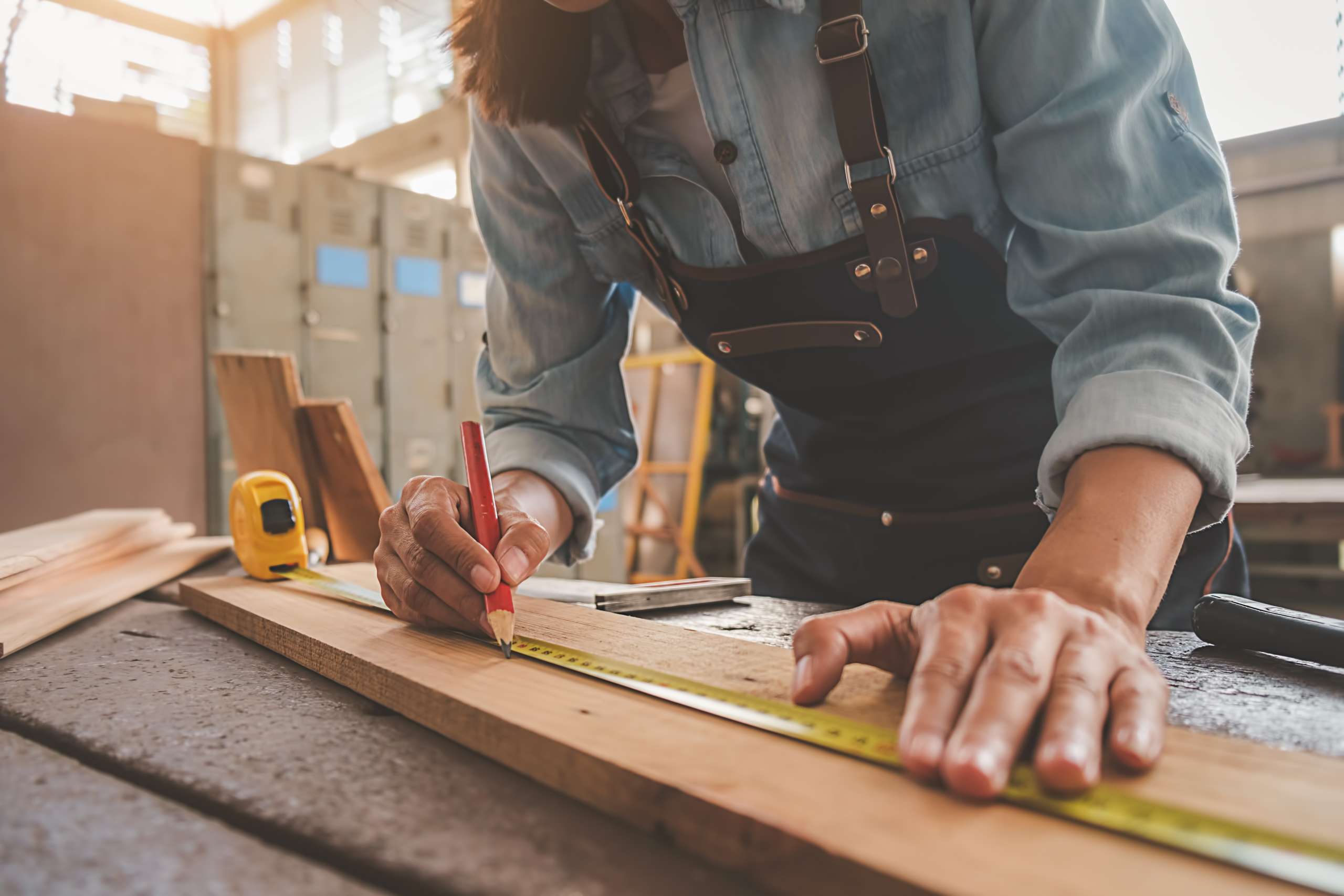 A carpenter works with carpentry tools