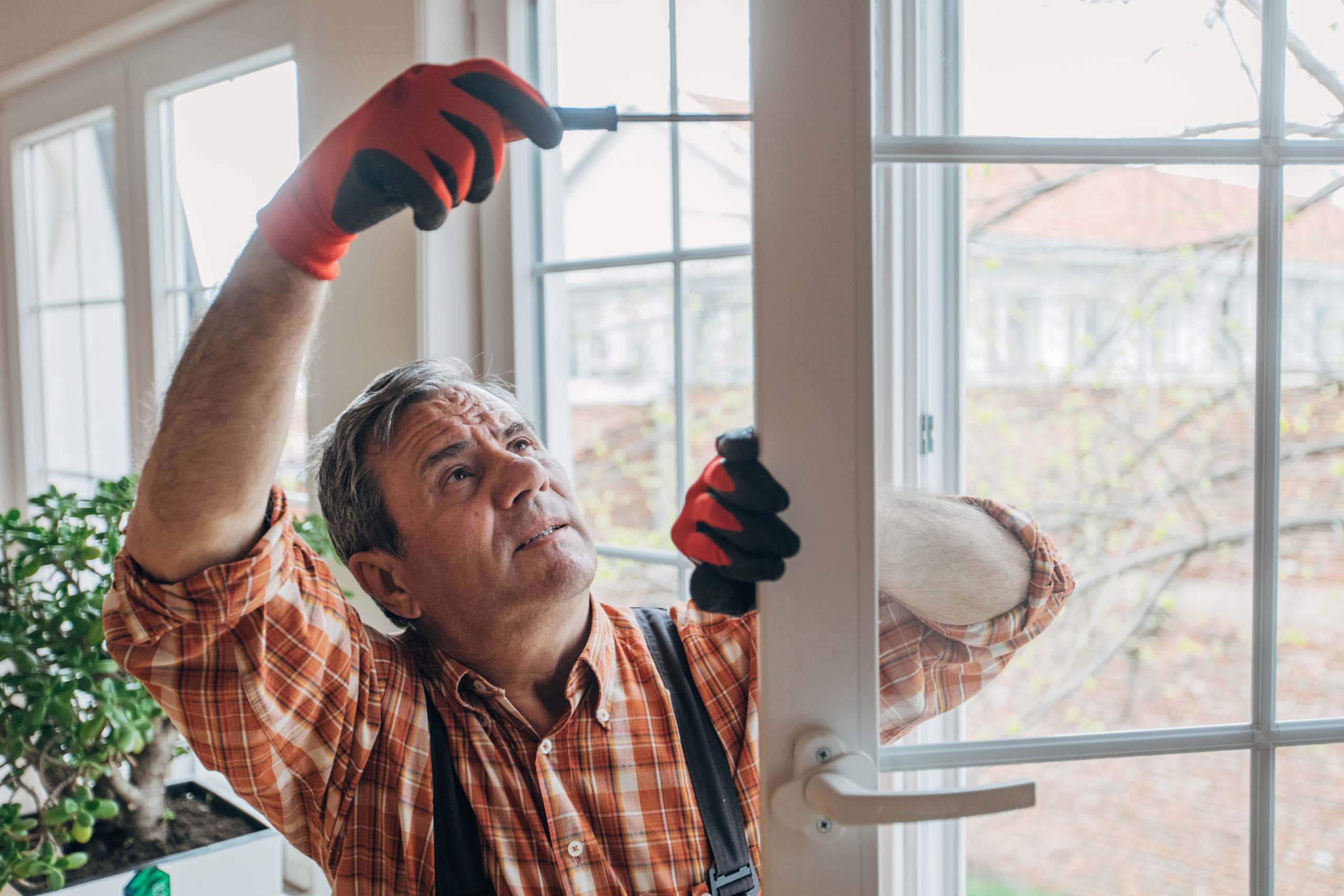 Handyman repairs a window