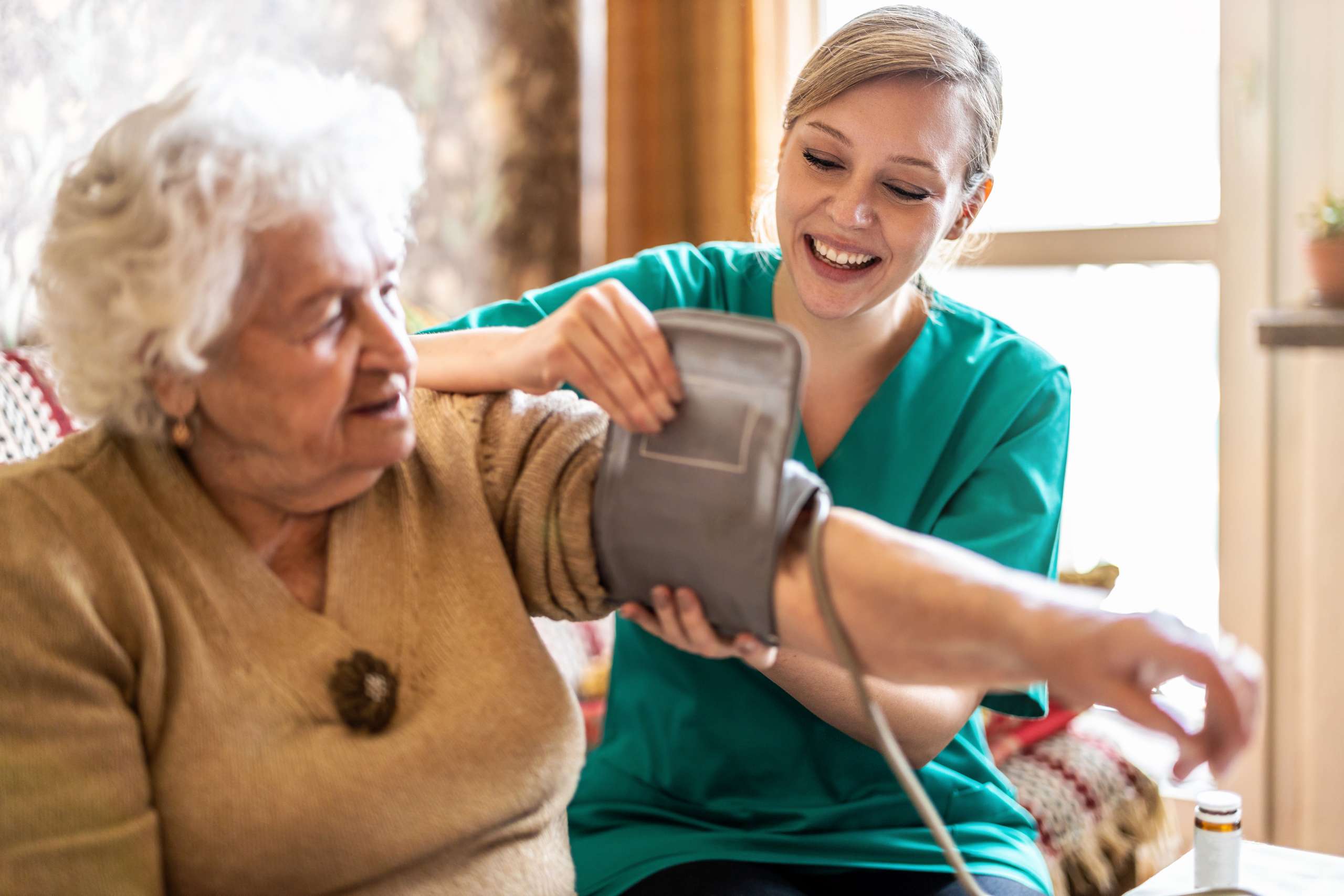 A nurse measures senior woman's blood pressure