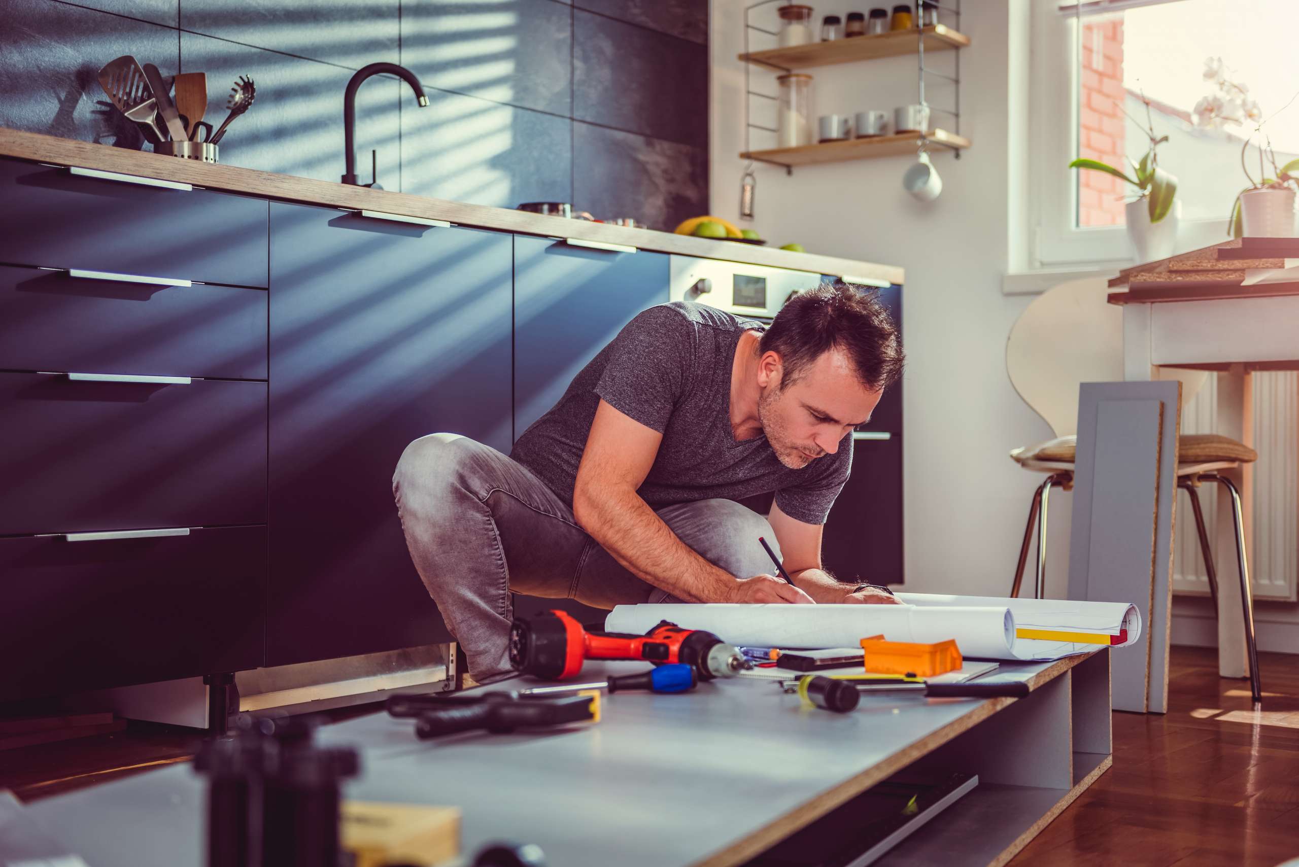 A contractor worker checks kitchen cabinet