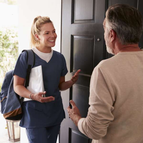 A healthcare worker visists a senior man at home