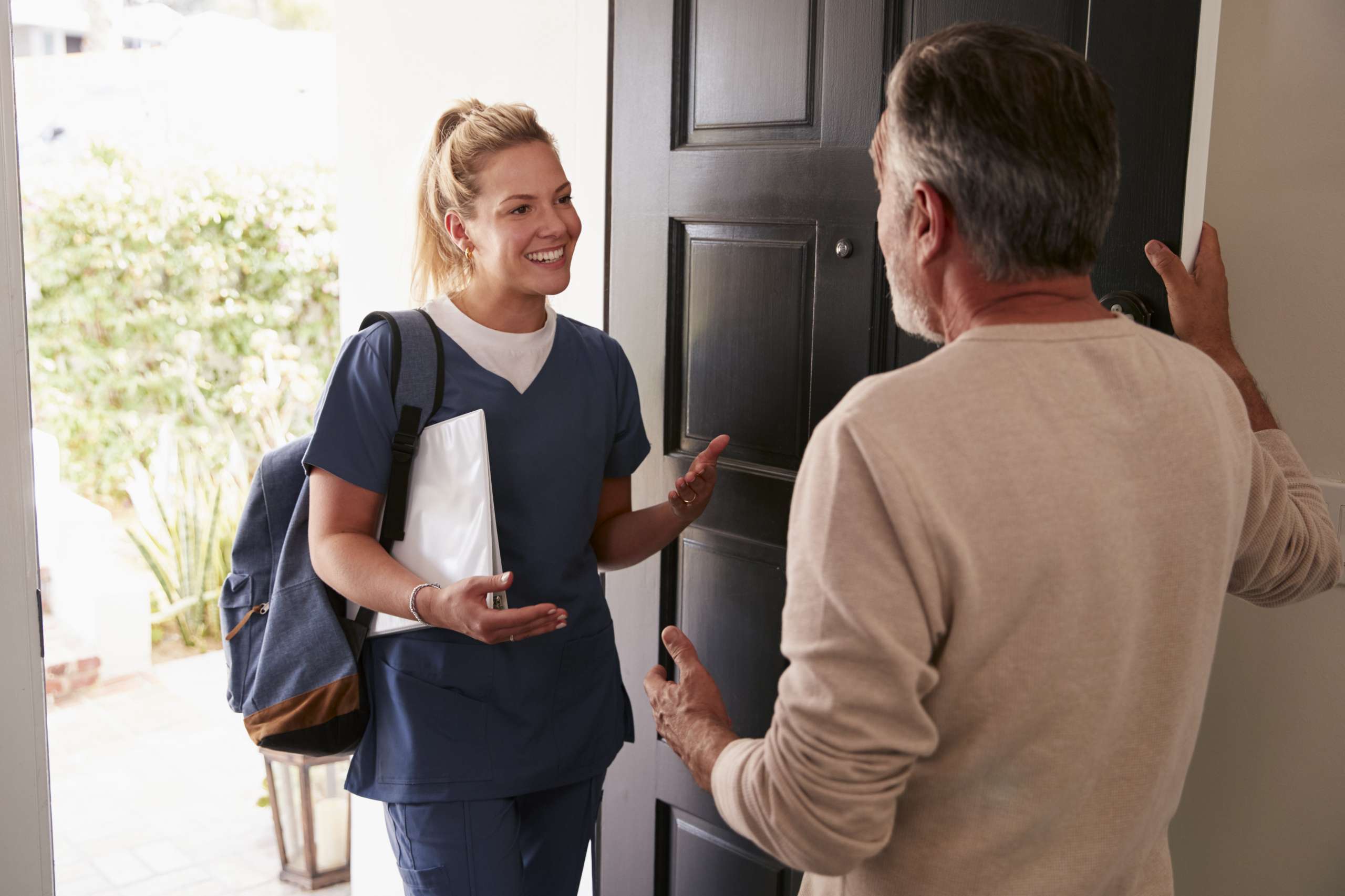 A healthcare worker visists a senior man at home