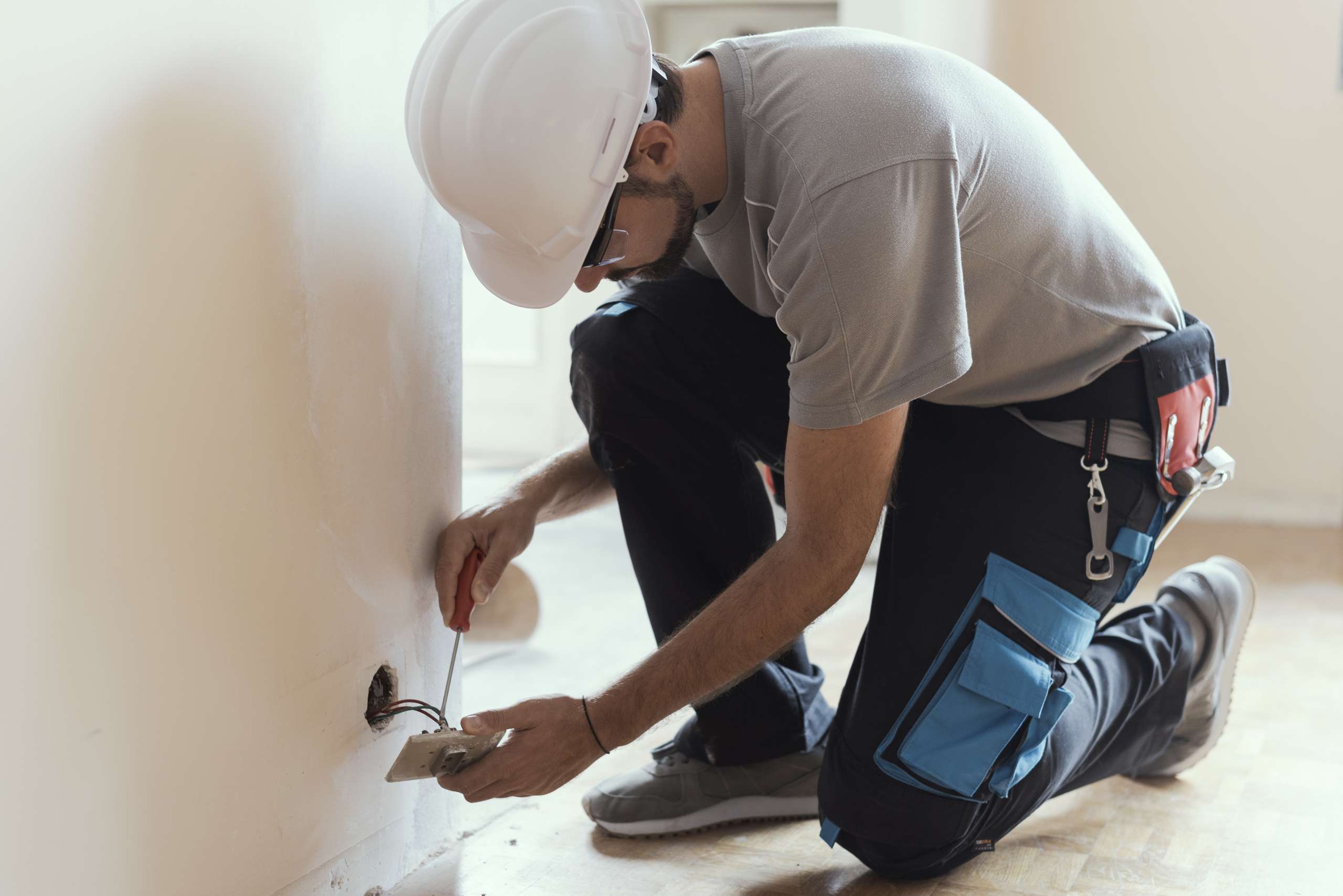 An electrician installs sockets