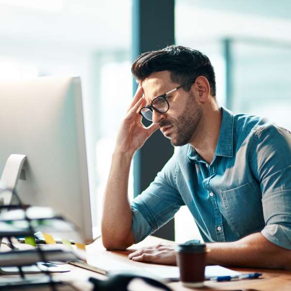 A business person looks at computer in an office