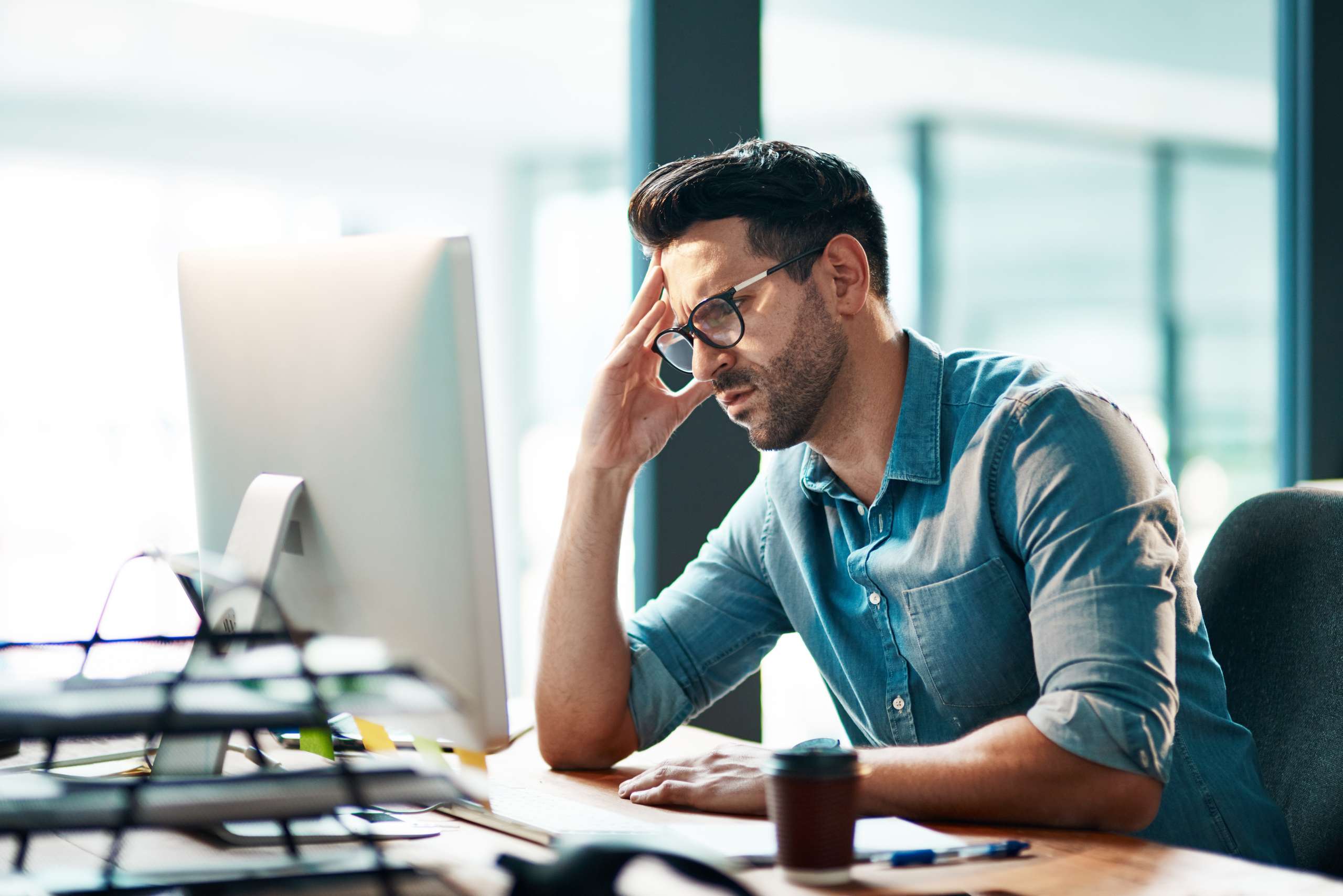 A business person looks at computer in an office