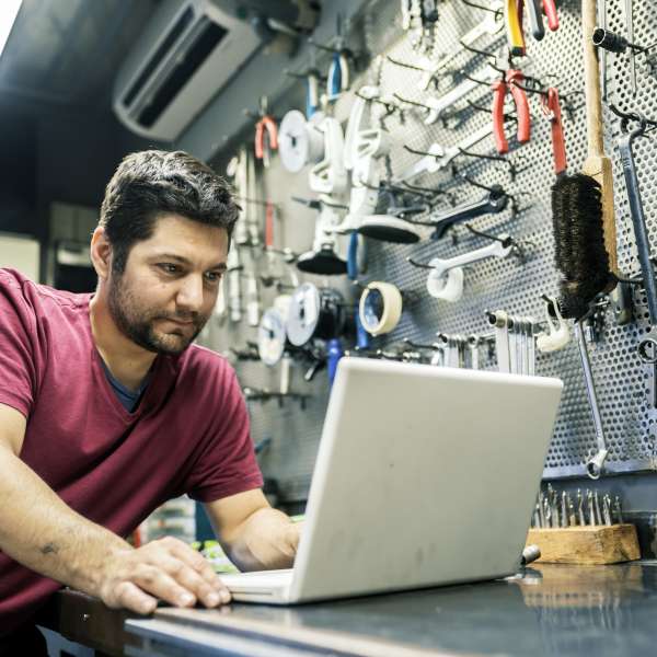 A business owner at his office with a laptop