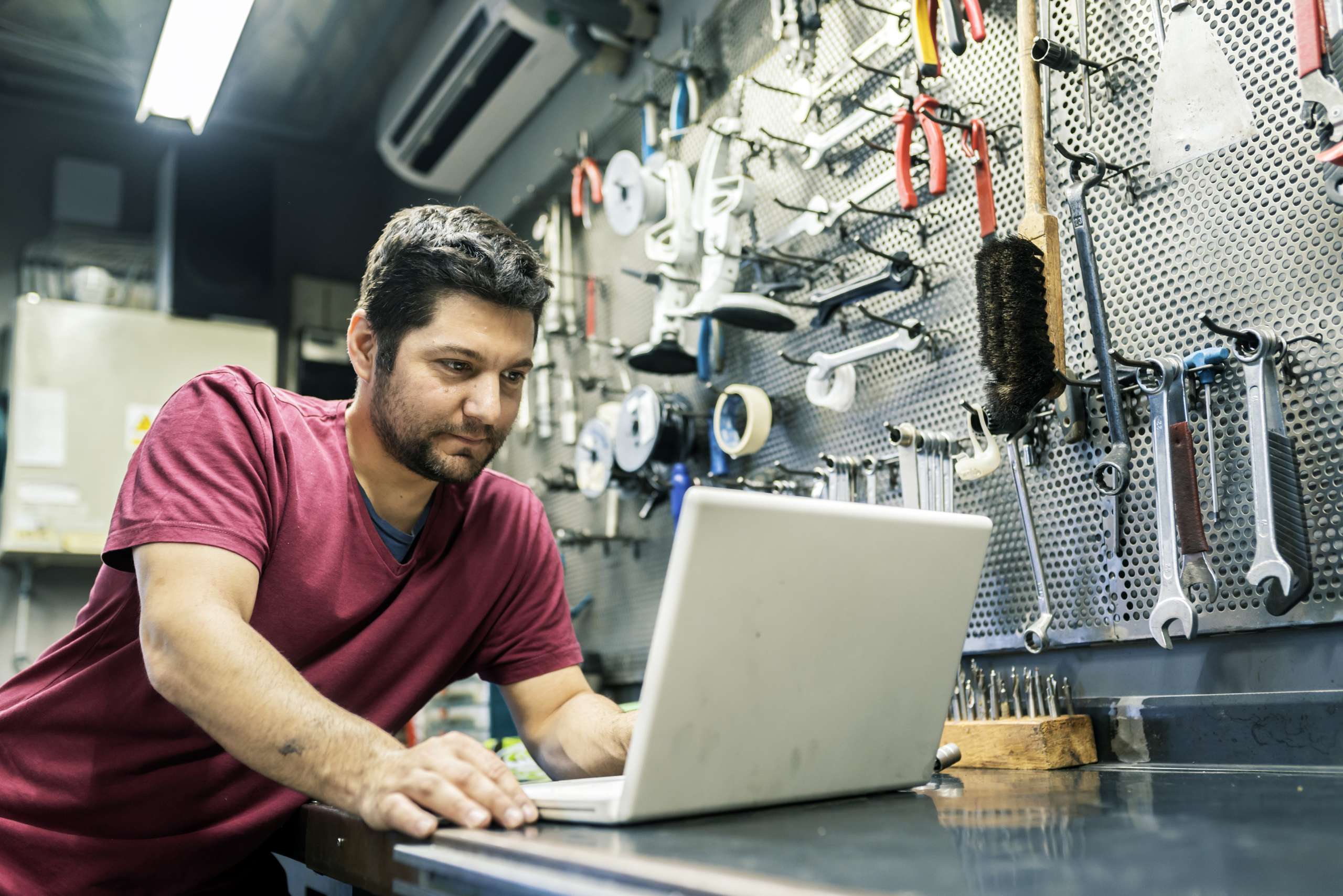 A business owner at his office with a laptop