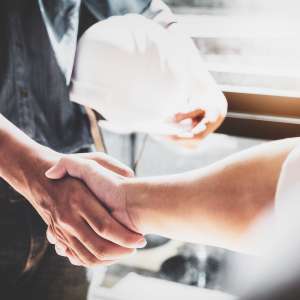 Two business persons handshake