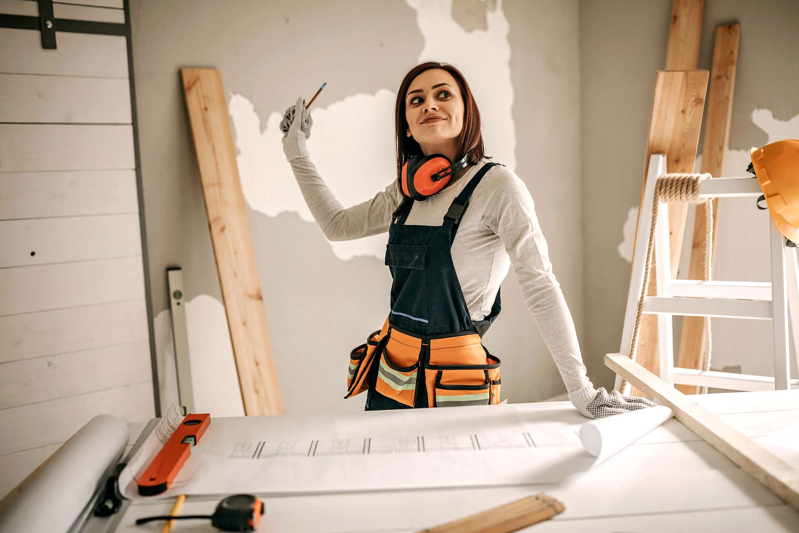 A painter white paints on a wall