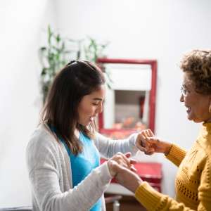 Nurse supporting senior patient walking the stairs at home