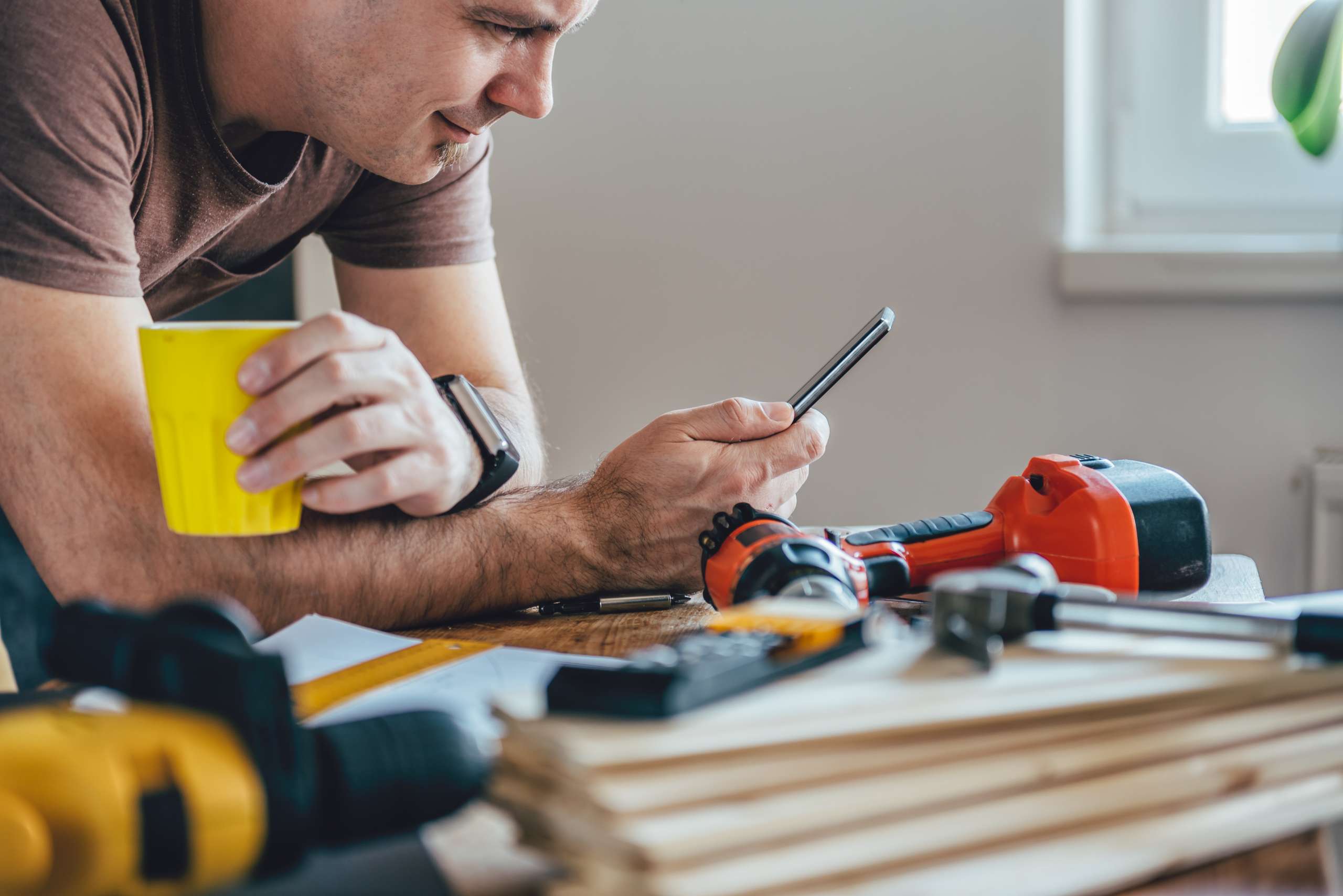 A handyman using smart phone for business