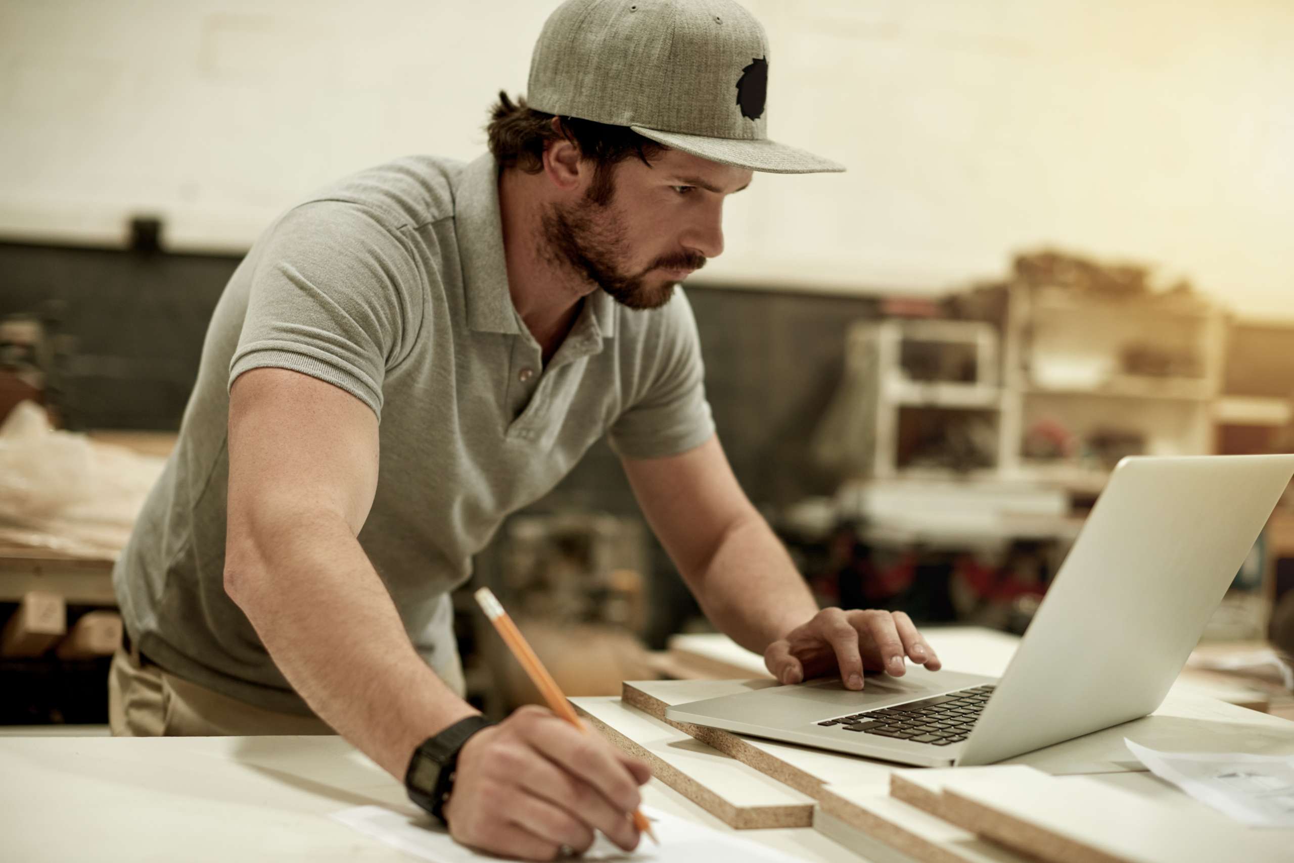 A handyman writes business planning in his workshop