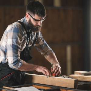 Young carpenter working in his workshop