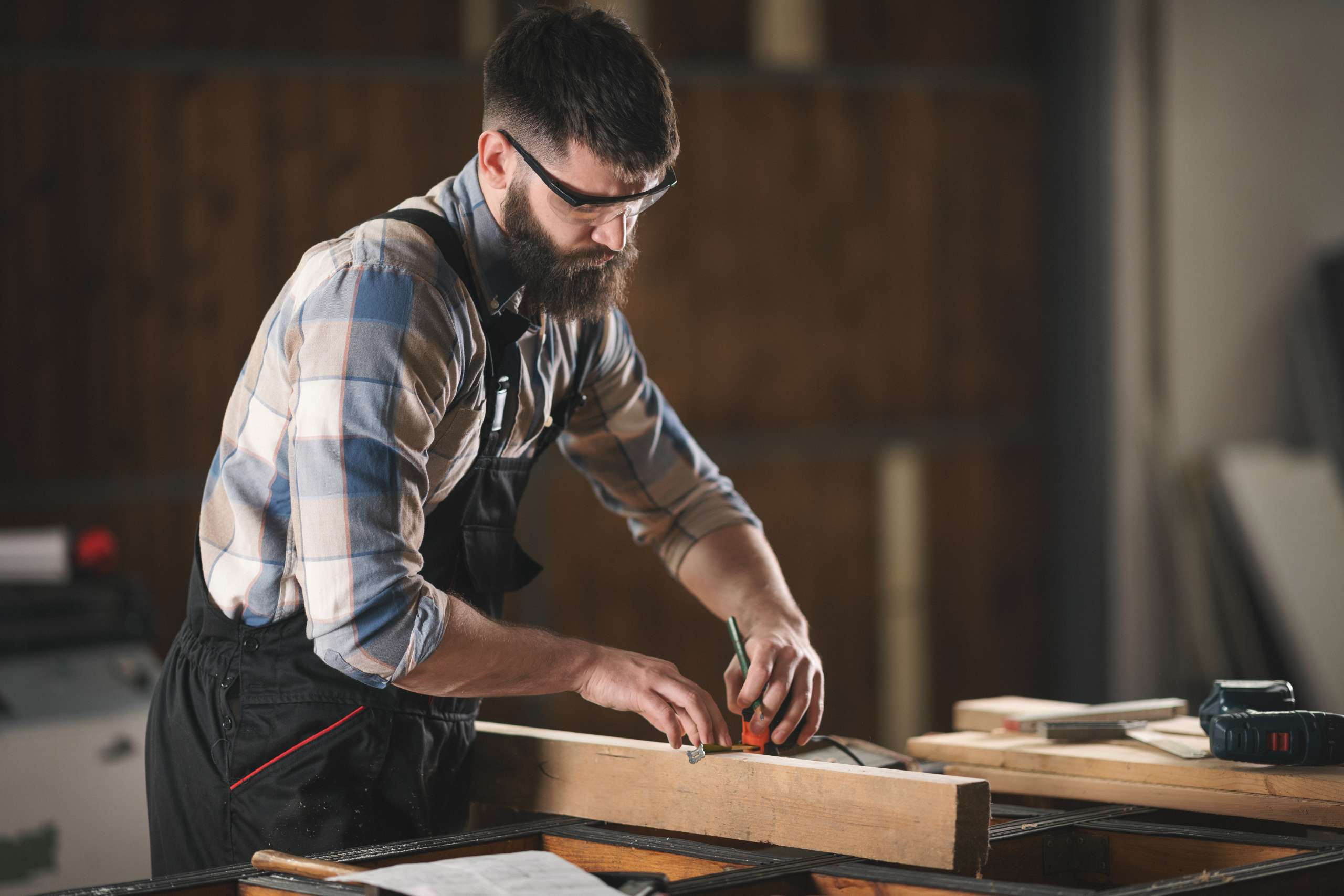 Young carpenter working in his workshop