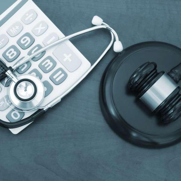 Home health equipment - Judge gavel, calculator and stethoscope