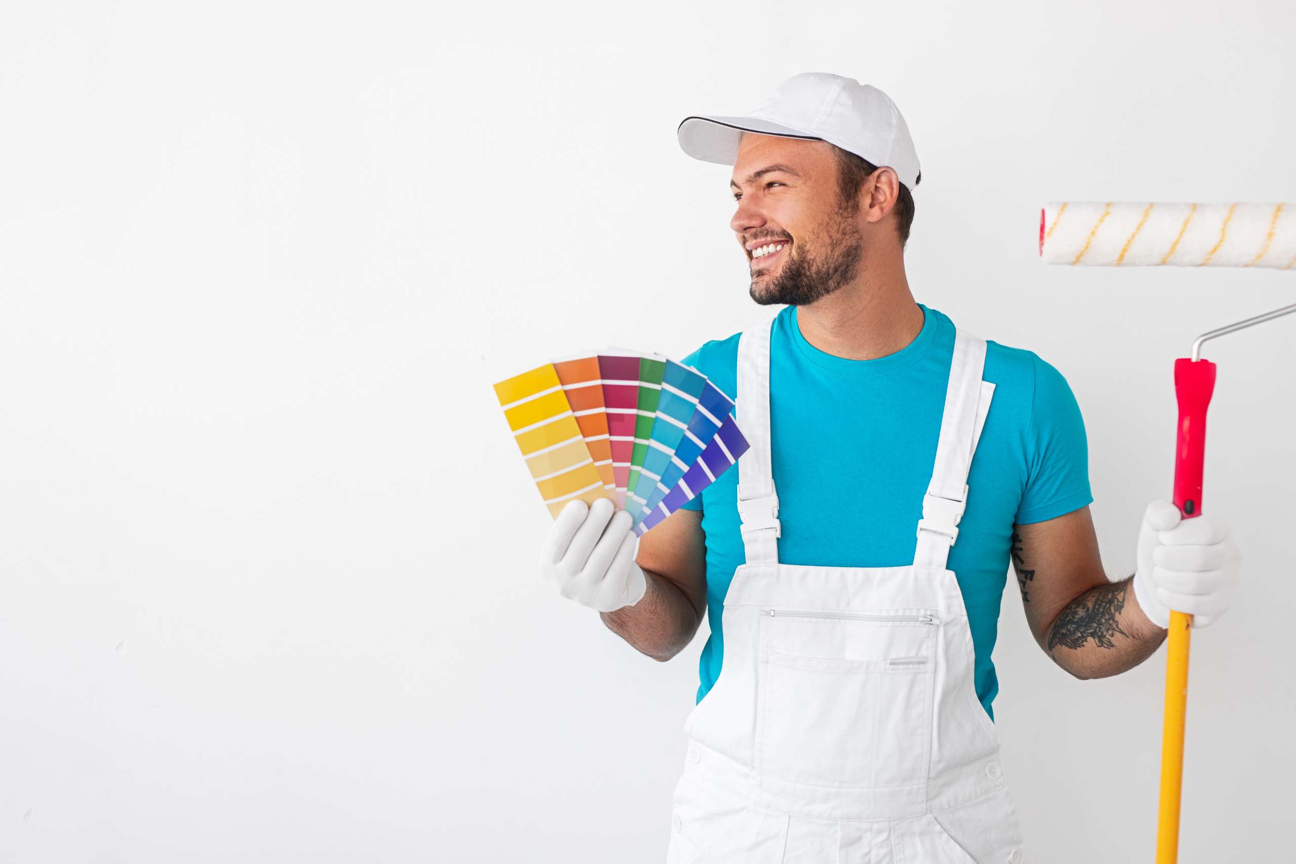 A happy house painter with roller and samples