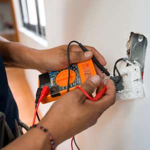 Electrician fixing an electrical outlet