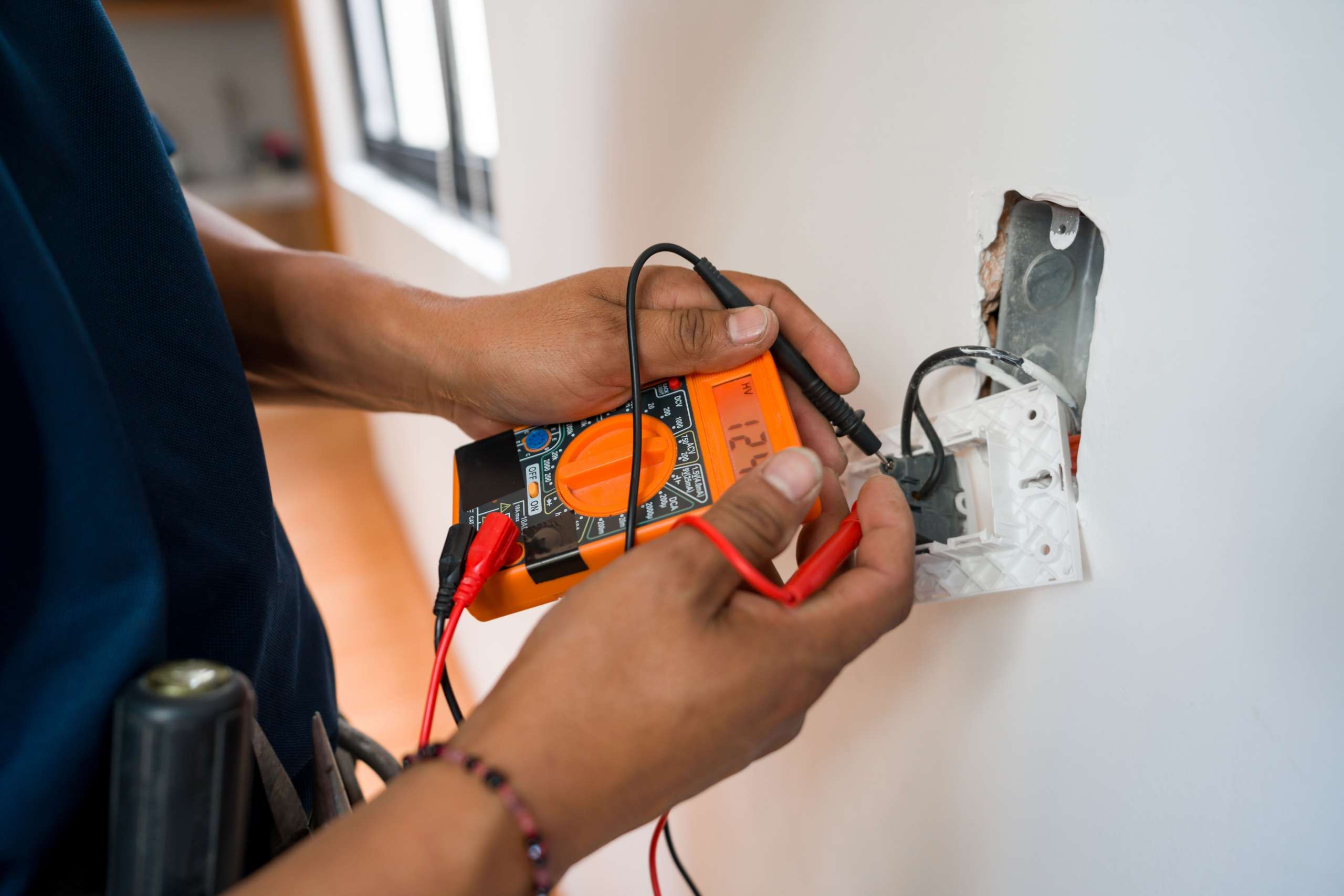 Electrician fixing an electrical outlet