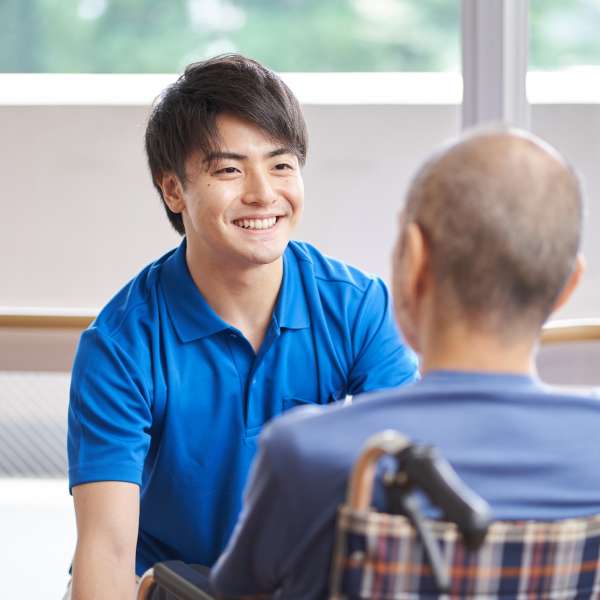 A caregiver with a wheelchair-riding senior