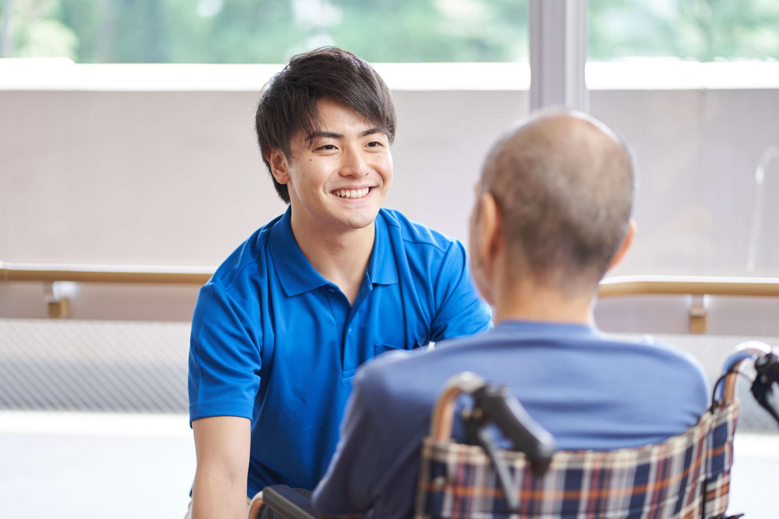 A caregiver with a wheelchair-riding senior