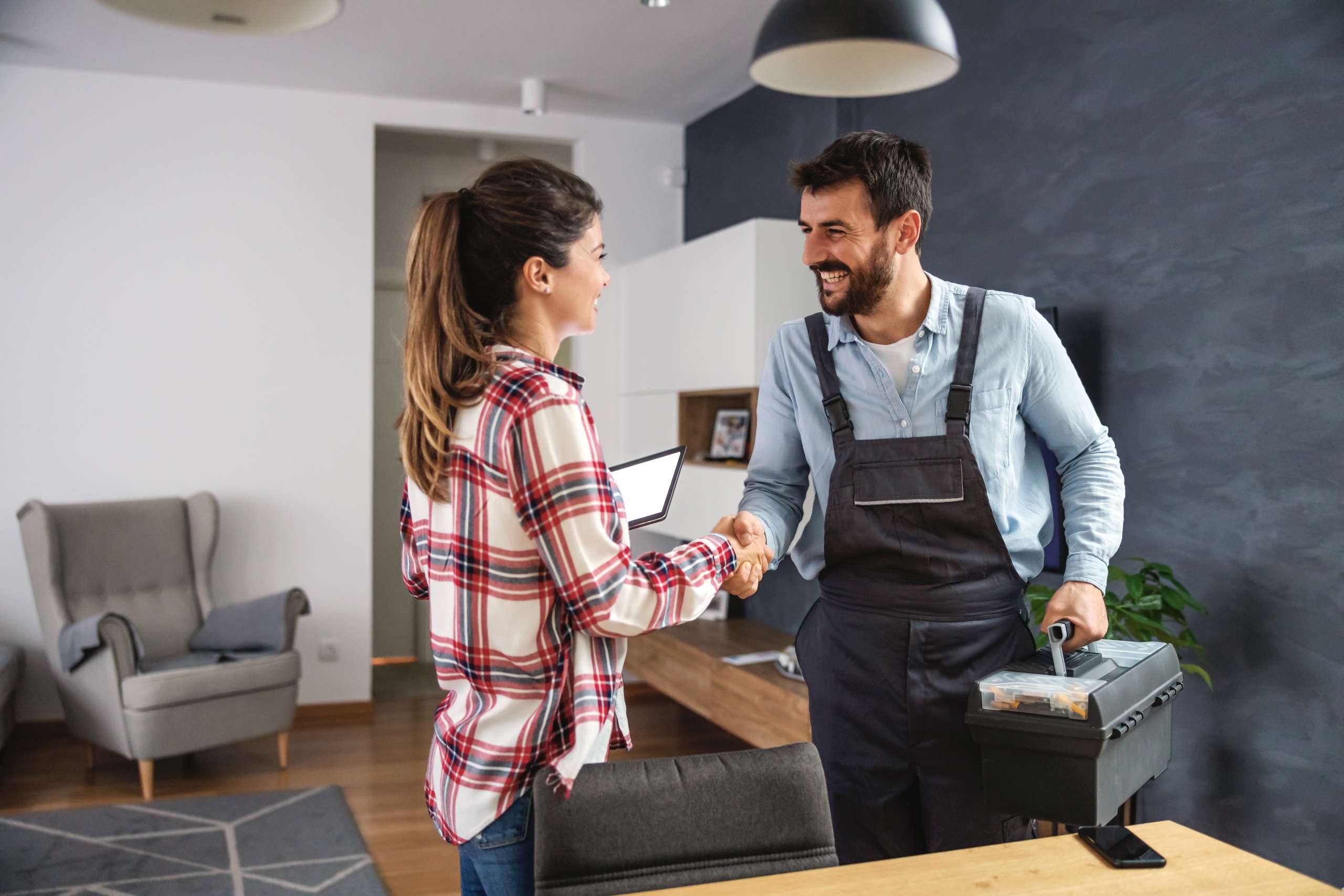 A customer shaks hands with handyman