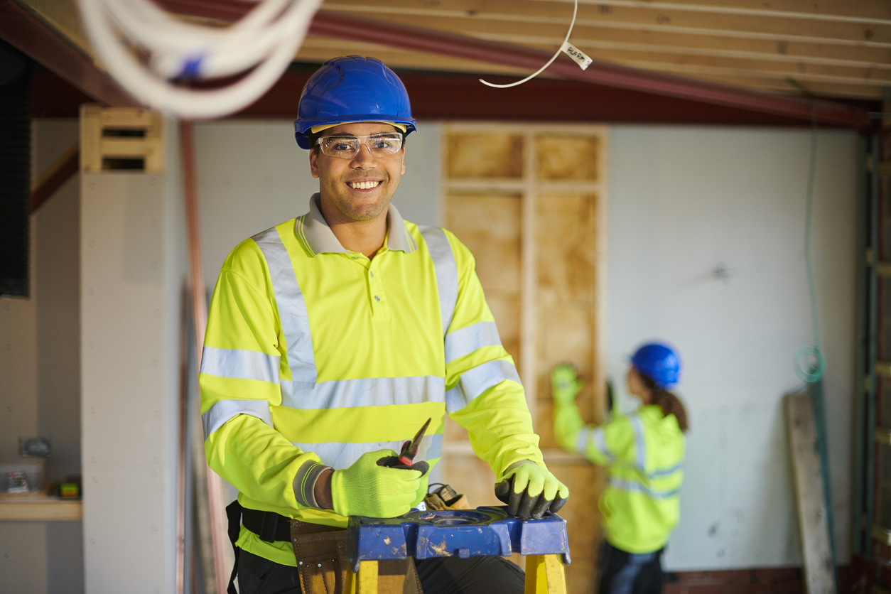 A happy electrician working on site