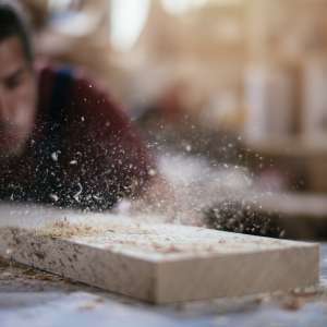 A carpenter working with wood at workshop