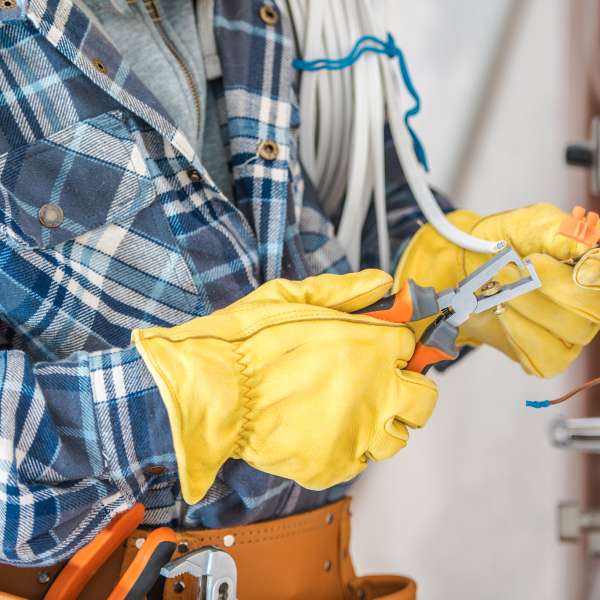 A professional electrician working with wires