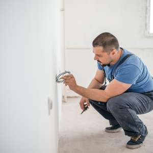 An electrician installs electricals