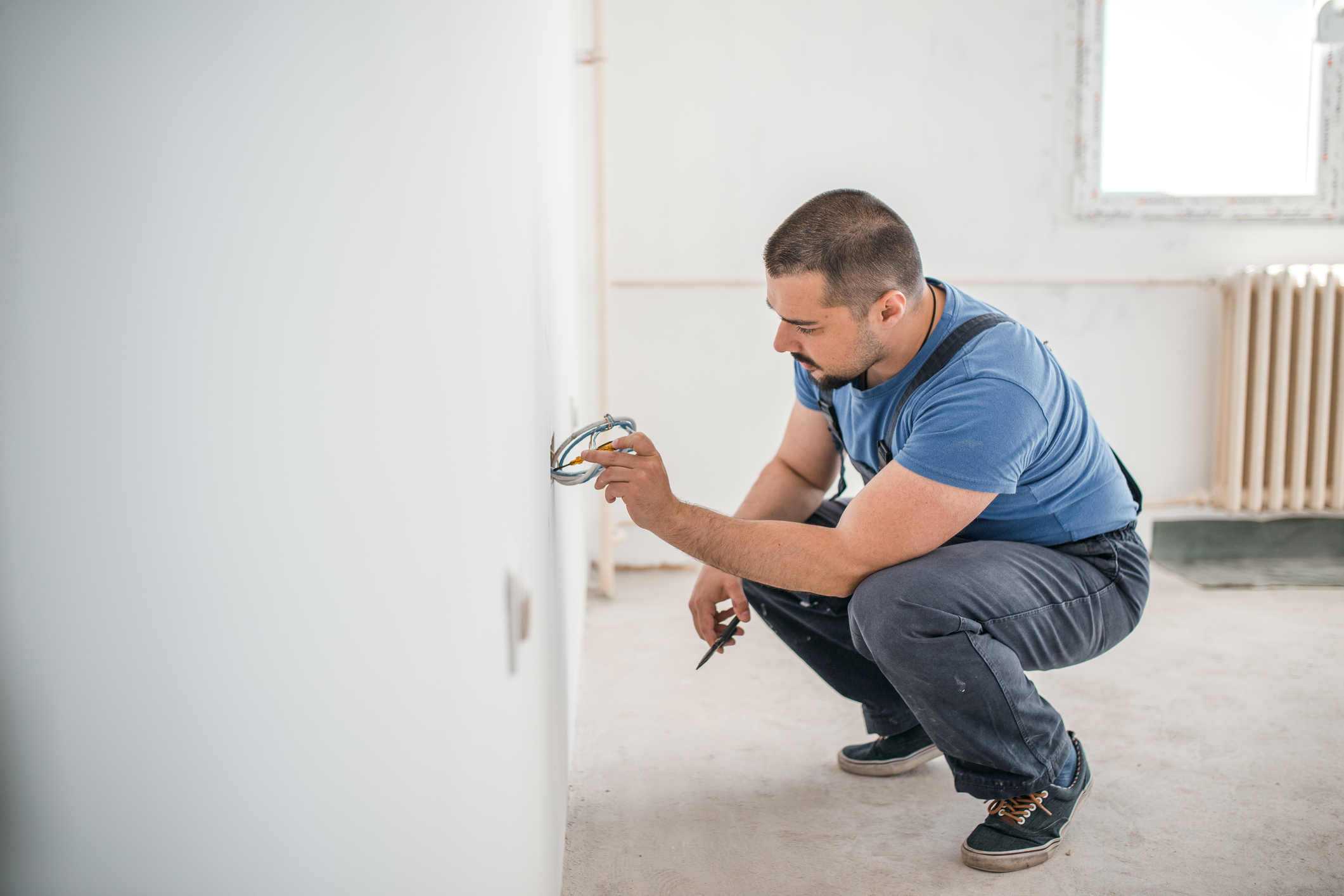 An electrician installs electricals