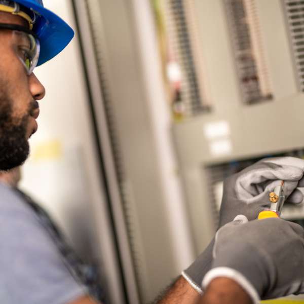 An electrician stripping a wire