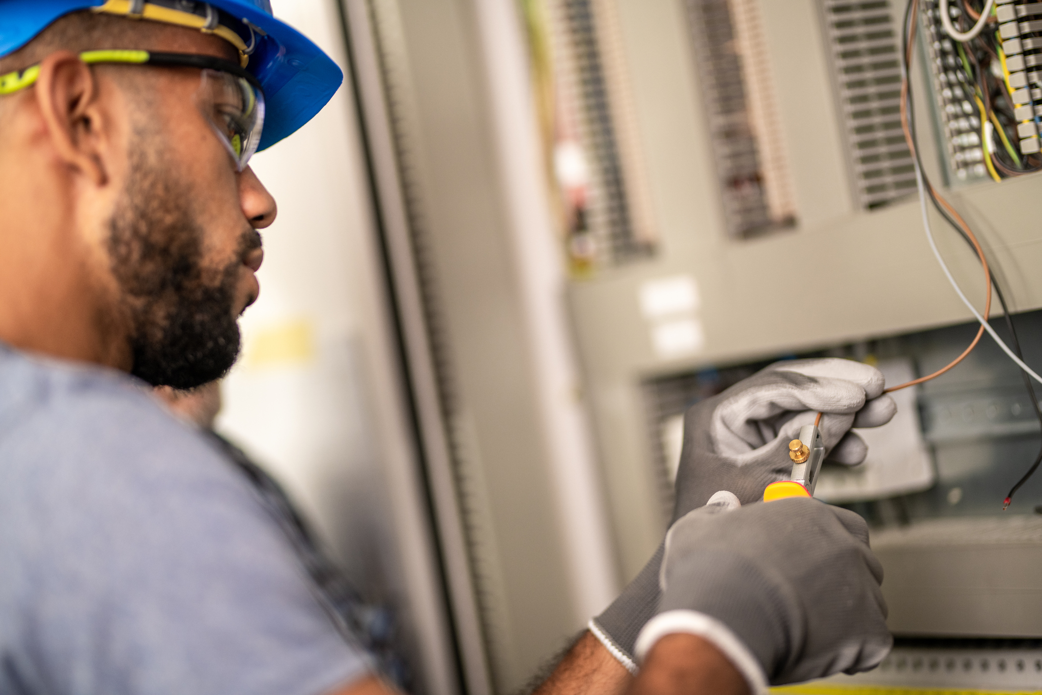 An electrician stripping a wire