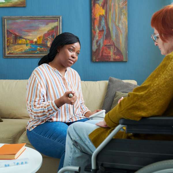Nurse checking blood pressure of senior woman