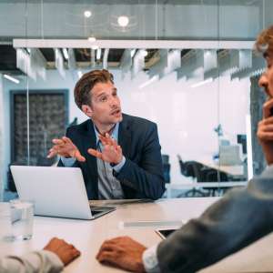 Group of business persons talking in the office.