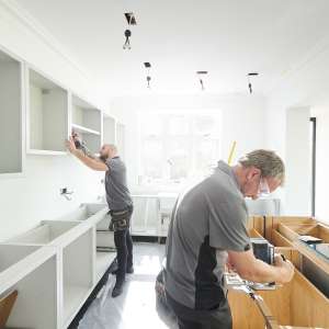 Two carpenters fitting a kitchen