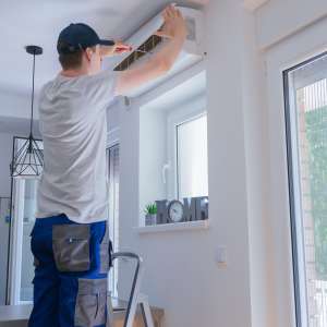 A technician repairing air conditioner.